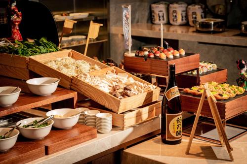 a table with a bottle of wine and boxes of food at Crowne Plaza Hangzhou Riverside by IHG in Hangzhou