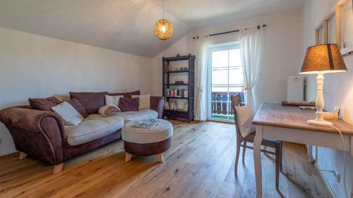 a living room with a couch and a table at Ferienwohnung Sonnenkind Altaussee in Altaussee