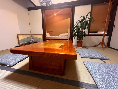 a wooden table in a room with a mirror at Dormitory Omitsu in Nara