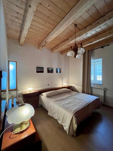 a bedroom with a bed and a table with a lamp at Pucino apartments in Trieste