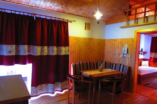 a room with a table and chairs and a bedroom at Chata u vinára Milana, Tatralandia in Liptovský Mikuláš