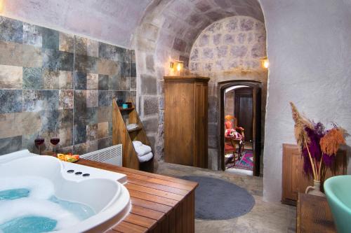 a bathroom with a sink and a tub in a room at Vigor Cappadocia - Special Class in Uchisar