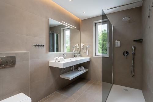 a bathroom with a sink and a shower at Hotel Ivka in Dubrovnik