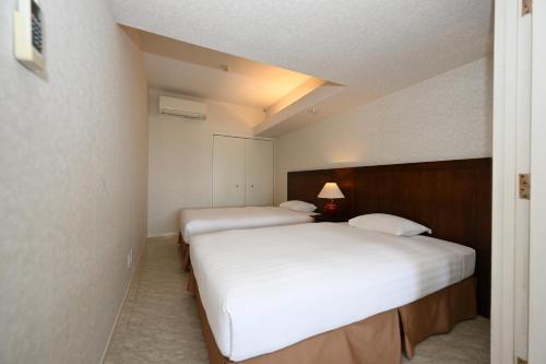 Ένα ή περισσότερα κρεβάτια σε δωμάτιο στο Hotel Royal Marine Palace Ishigakijima