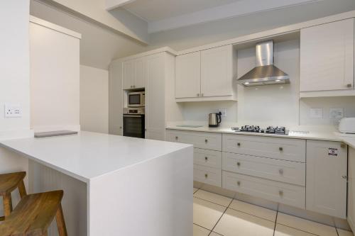 a kitchen with white cabinets and a white counter top at San Lameer Villa 2609 - 3 Bedroom Superior - 6 pax - San Lameer Rental Agency in Southbroom