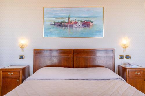a bedroom with a bed and a painting on the wall at Hotel Panorama in Venice-Lido