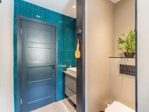 a bathroom with a blue door and a sink at Seabrook House in Hythe