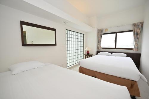 Ένα ή περισσότερα κρεβάτια σε δωμάτιο στο Hotel Royal Marine Palace Ishigakijima