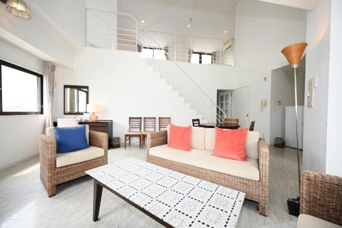 a living room with two chairs and a table at Hotel Royal Marine Palace Ishigakijima in Ishigaki Island