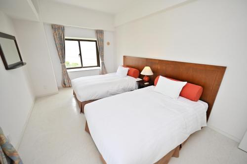 Ένα ή περισσότερα κρεβάτια σε δωμάτιο στο Hotel Royal Marine Palace Ishigakijima