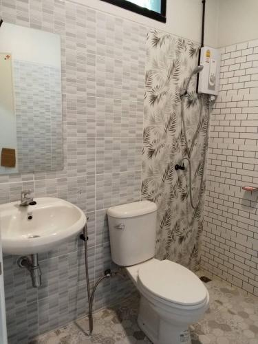 a bathroom with a toilet and a sink at Khlong Thom Resort in Khlong Thom