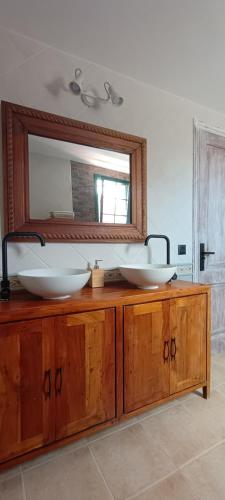 a bathroom with two sinks and a mirror at Casa Luz in Yaiza