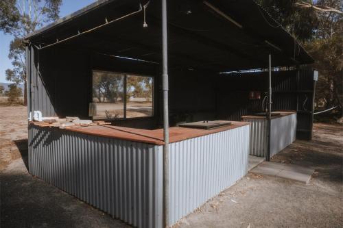 a building with a black roof with a counter at 2BR Tiny Family Home at Grampians Edge by Tiny Away in Dadswells Bridge