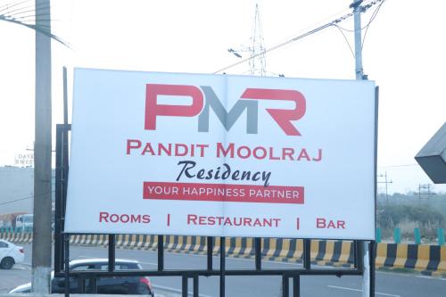 a sign for a parkinian modern restaurant on a highway at Pt Moolraj Residency in Una