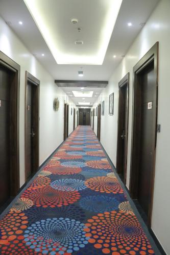 a hallway with a colorful carpet on the floor at Pt Moolraj Residency in Una