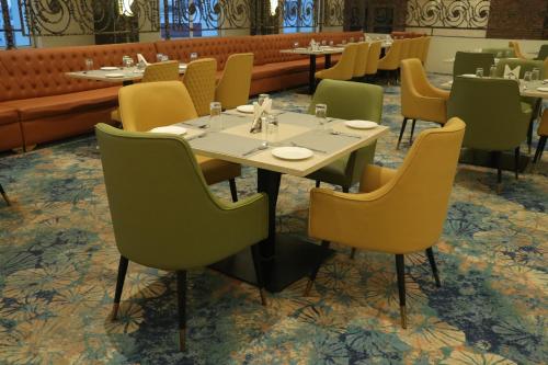 a dining room with a table and chairs at Pt Moolraj Residency in Una