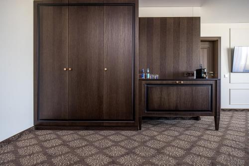 a room with a wooden cabinet and a desk at Gradiali Wellness and SPA in Palanga