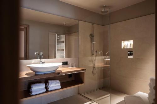 a bathroom with a sink and a shower at Adler Spa Resort Dolomiti in Ortisei