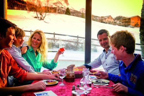 a group of people sitting at a table in a restaurant at VTF Les Balcons du Sauze in Le Sauze