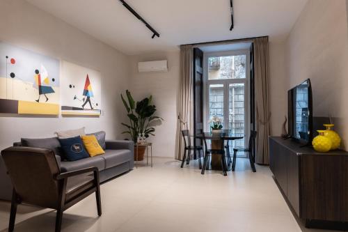 un soggiorno con un divano e una TV di Aledo Boutique Apartments a Napoli
