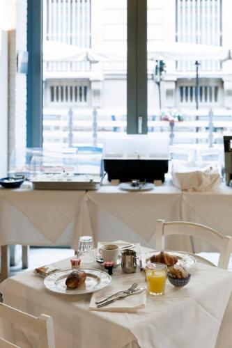 a table with two plates of food on it at Palazzo Bellezia Luxury Suites & Spa in Turin