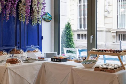 a table with food and pastries on it at Palazzo Bellezia Luxury Suites & Spa in Turin