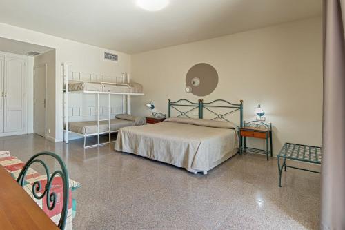 a bedroom with two bunk beds and a table at Hotel Castell Blanc in Empuriabrava