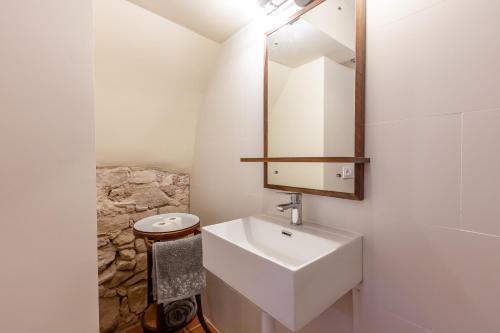 a bathroom with a sink and a mirror at Cal Simon- Casa a Montserrat in Collbató