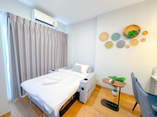 a hospital room with a bed and a chair at Astra Sky River Chang Klan Chaing Mai in Chiang Mai