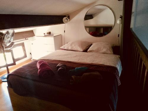 a bedroom with a large bed and a mirror at Villa club avec jardin in Bandol