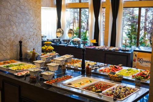 a buffet line with many different types of food at Maxi Park Hotel & Spa in Velingrad