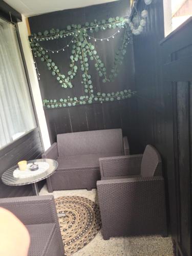 a patio with chairs and a table and a wall with lights at Ferienwohnung AltePost in Bad Aussee