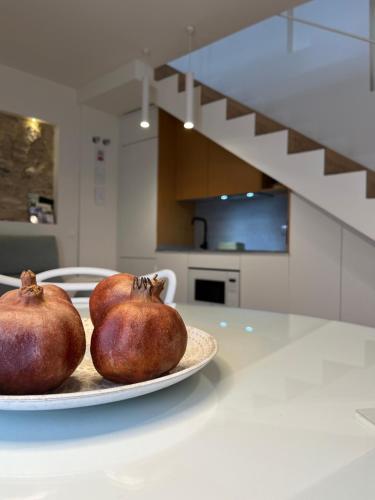 two pears on a plate on a kitchen counter at Casa Torre Hacho in Antequera