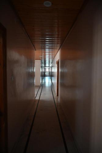 an empty hallway in a building with a hallway at Hotel Atul Regency in Rāmpur