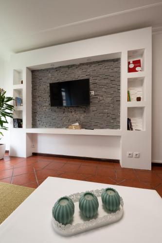 a living room with two green watermelons in front of a fireplace at Lovely house, Paredes Alenquer in Alenquer
