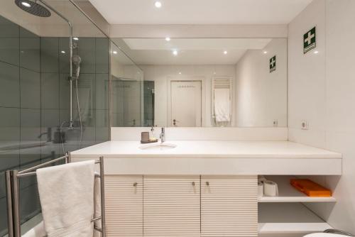 a bathroom with a sink and a mirror at Marias River Apartment in Porto