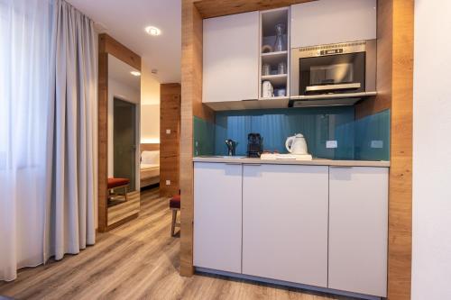 Kuchyň nebo kuchyňský kout v ubytování Naco Aparthotel by Arca Spa