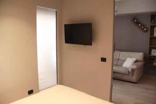a room with a mirror and a television on a wall at LUX APARTMENT CAPANNELLE in Rome
