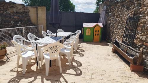 a group of white tables and chairs on a patio at La Via Verde in Miguel-Ibáñez