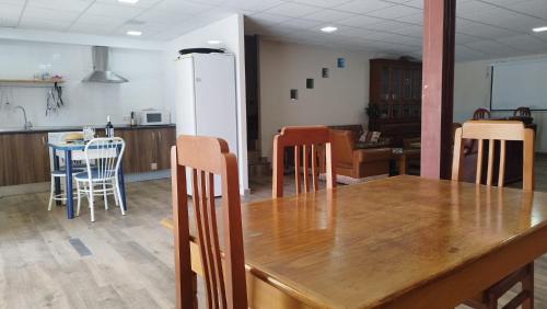 a dining room with a wooden table and chairs at La Via Verde in Miguel-Ibáñez
