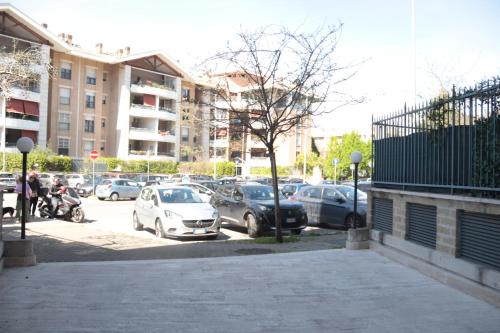a parking lot with cars parked in front of buildings at LUX APARTMENT CAPANNELLE in Rome