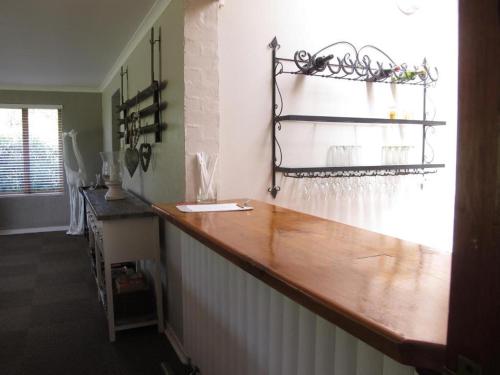 a kitchen with a counter with a wooden counter top at Midlands Forest Lodge in Balgowan