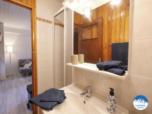 a bathroom with a sink and a mirror at "La bâtisse des prés" in Puy-Saint-Vincent