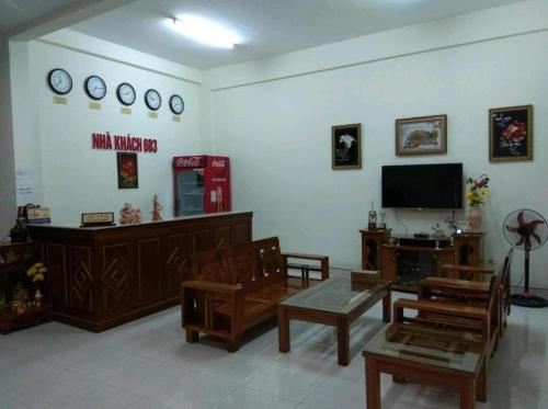 a living room with wooden furniture and a flat screen tv at Nhà Khách 683 DN - by BAY LUXURY in Da Nang