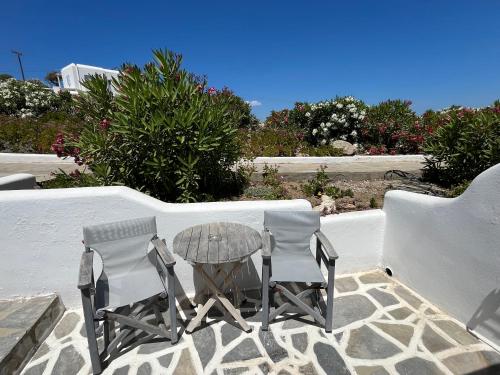 two chairs and a table on a patio at Villa Margarita in Mýkonos City