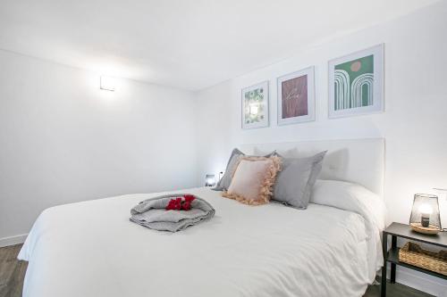 a white bedroom with a white bed with pillows at Loft El Ramonal in Candelaria