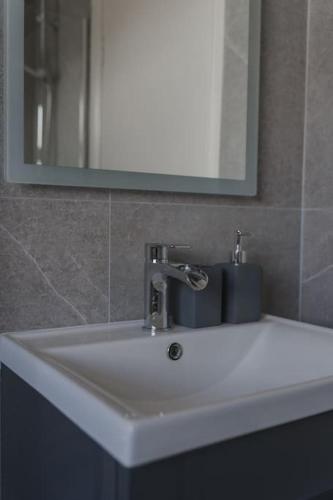 a white sink in a bathroom with a mirror at Elena Retreats in Drogheda