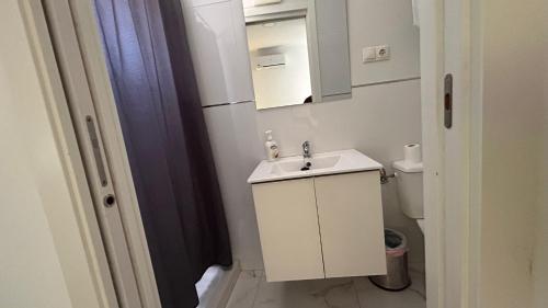 a small bathroom with a sink and a toilet at Pensión Barlovento in Málaga