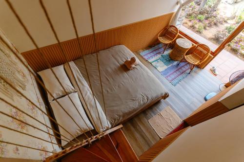 a small bed in a room with a window at Hoàng Gia Trang in Da Lat