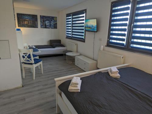 a room with a bed and a couch and windows at Comfortable Worker Studio - Free Parking in Asten